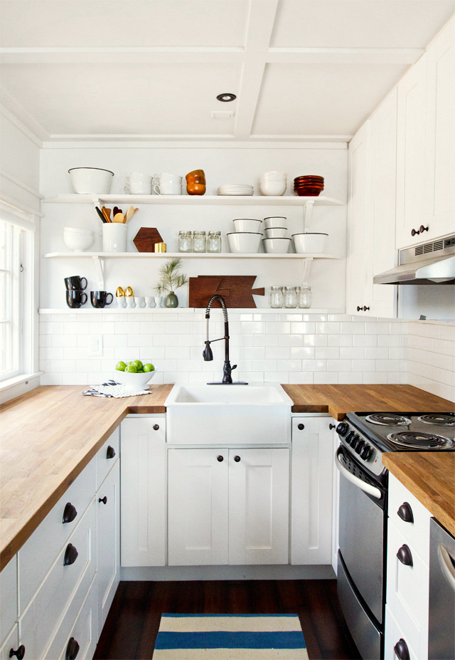 small white kitchen with white subway tile and open shelves by Sarah Sherman Samue