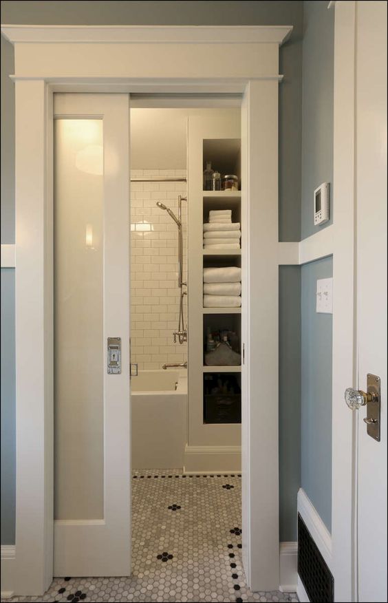 frosted glass doors are great for privacy in this bathroom