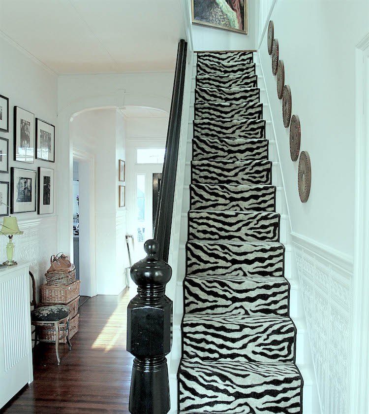 Nancy Keyes entry- hall- black and white animal skin runner staircase after