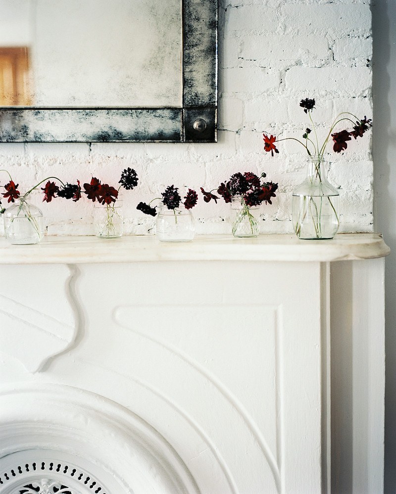 beautiful painted brick and old stone fireplace mantel designed by Michelle Willis Adams