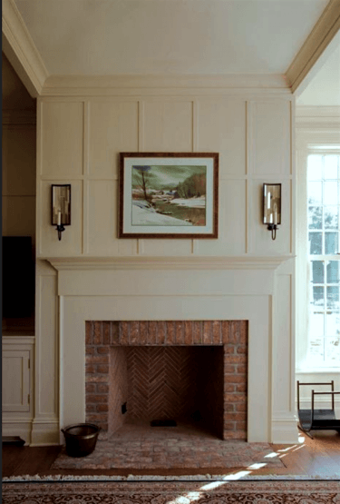 brick fireplace with beautiful mantel and paneled surround