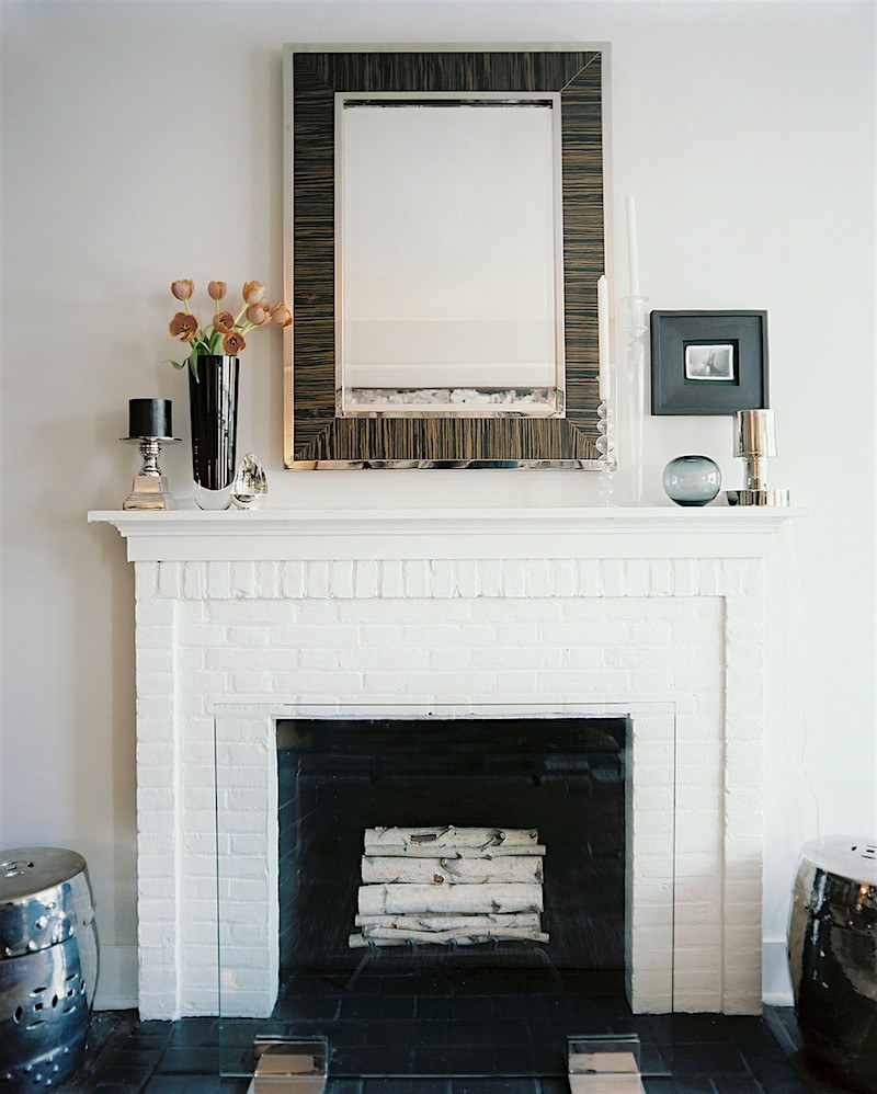 beautiful white-washed brick - painted white brick with wood piece on the top of the mantel - designed by Ron Marvin