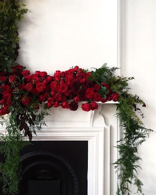 red roses and greens white fireplace mantel christmas decor