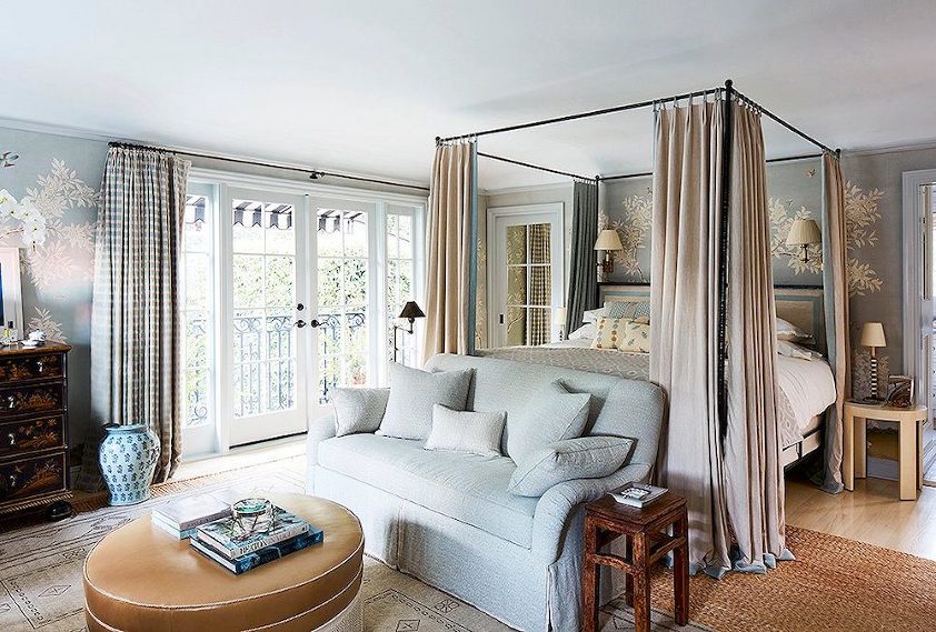 Mark D Sikes bedroom with four poster bed layered rugs and sofa - blue Gracie Wallpaper