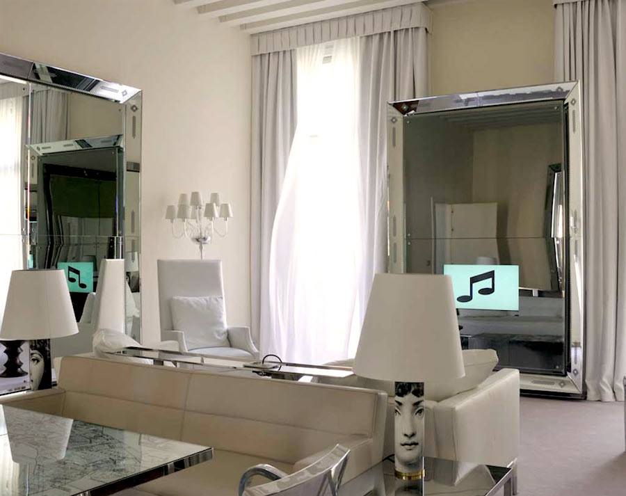 Phillipe Stark Hotel in Venice with living room TV coming through the mirror!