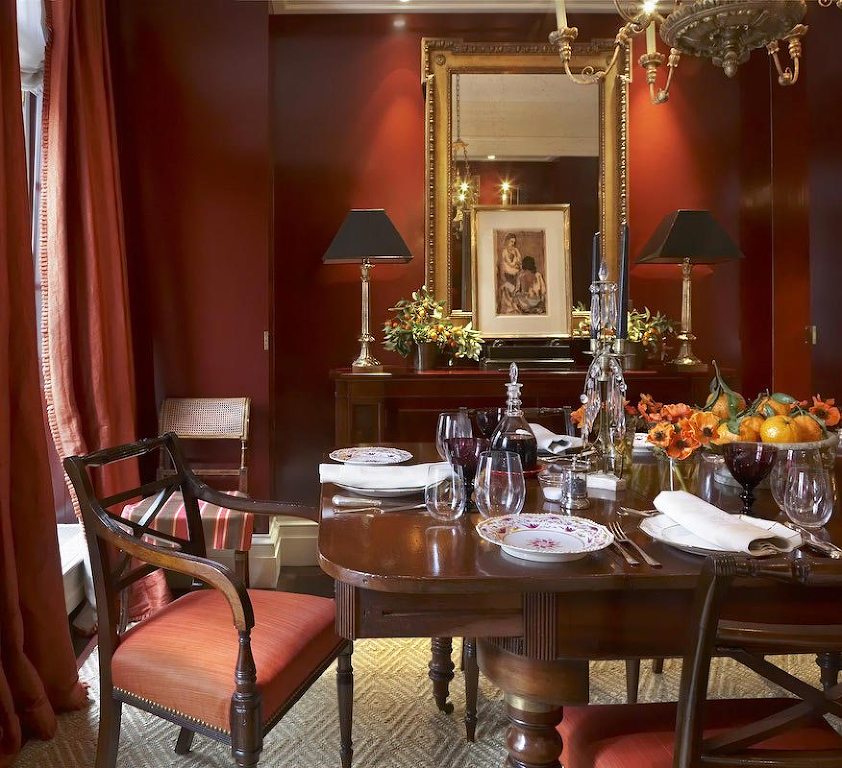 Gil Schafer dining room with warm rusty red walls - brown furniture - great color balance