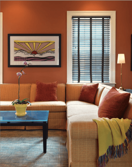out of place orange family room in a historic Greek Revival home