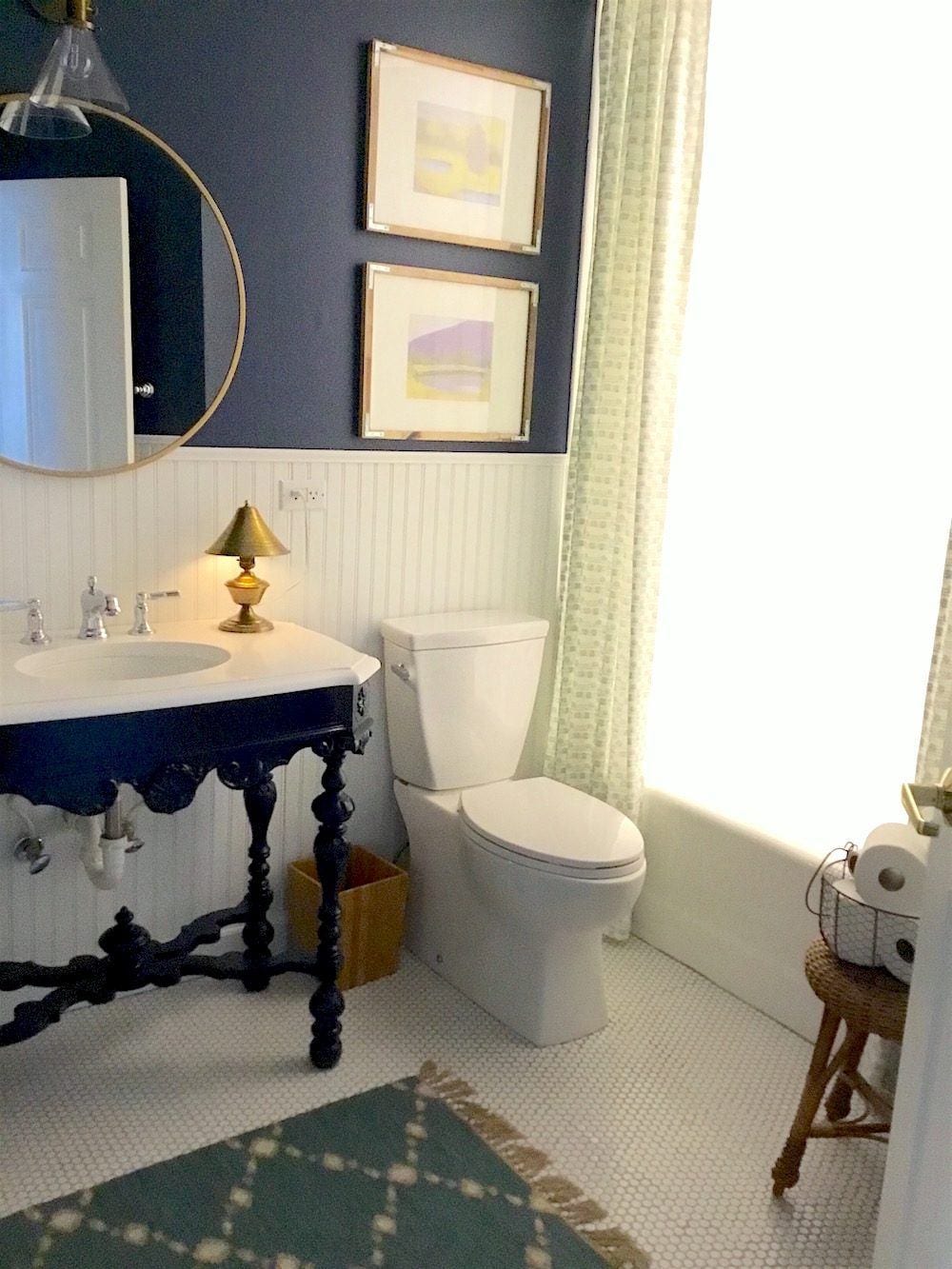 painted antique table in a bathroom used as a vanity