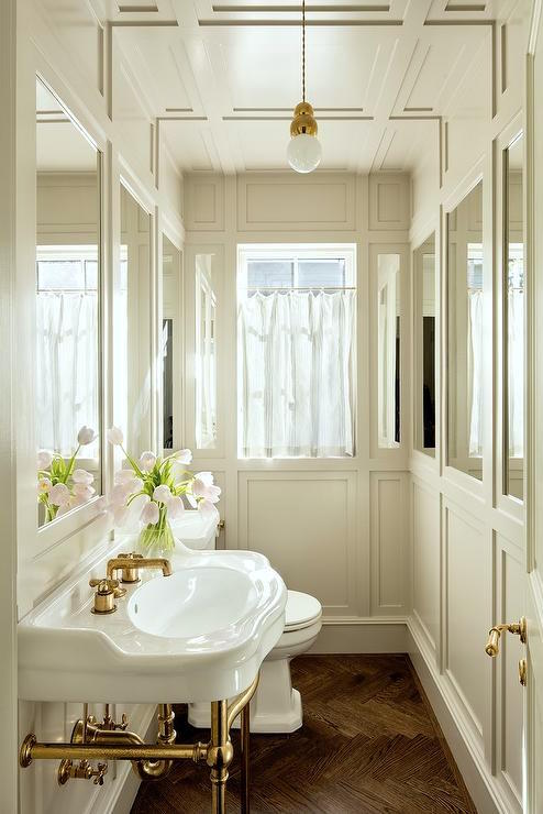 https://laurelberninteriors.com/wp-content/uploads/2018/07/10-37175-post/Jessica-Helgerson-chic-medicine-cabinet-powder-room-ivory-wainscoting.jpg