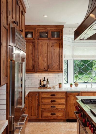Crown Point Cabinetry - handsome wooden kitchen - white subway tile