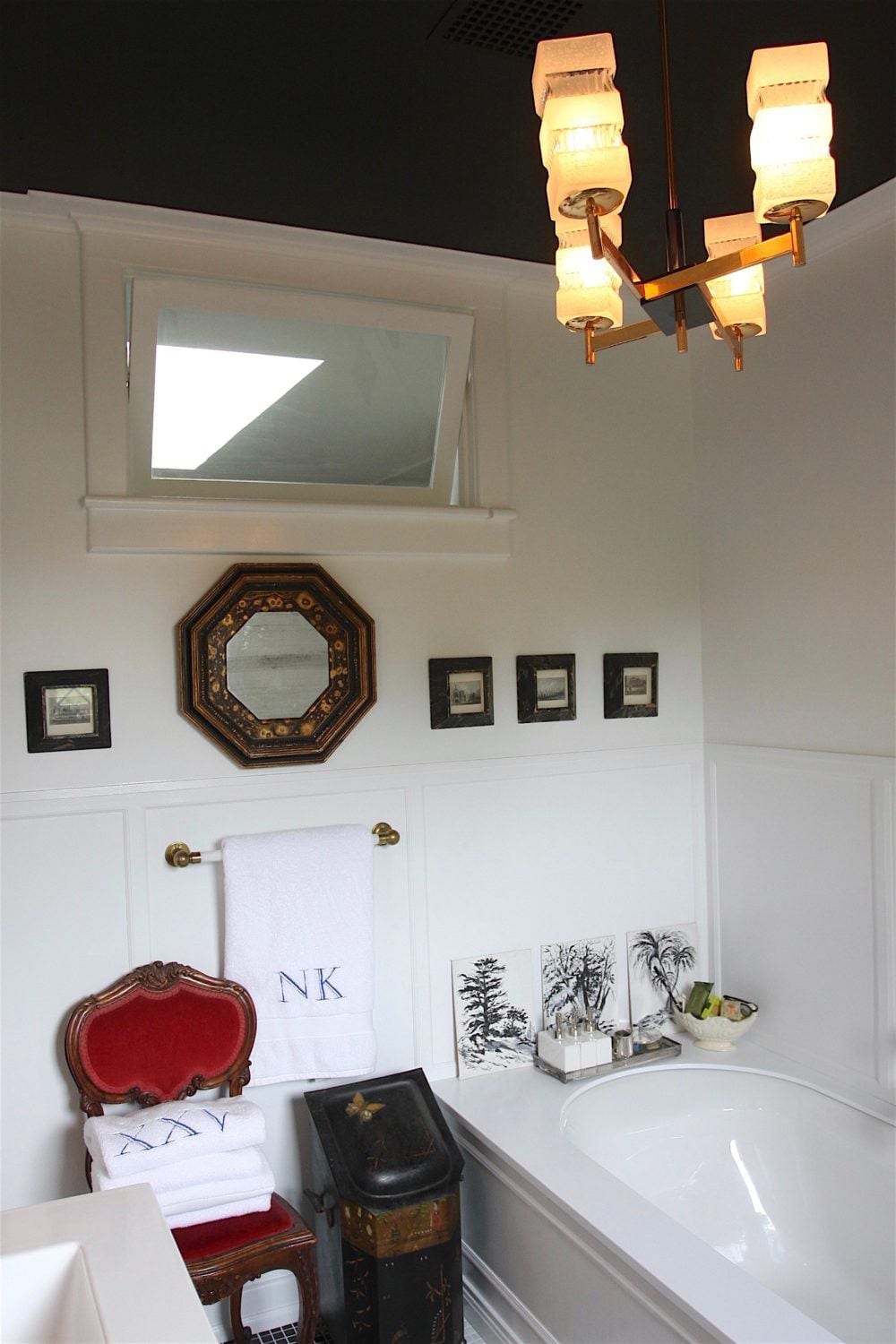 Nancy Keyes - bathroom after - wainscoting - brass chandelier - problem ceilings -Benjamin Moore Racoon Fur black ceiling