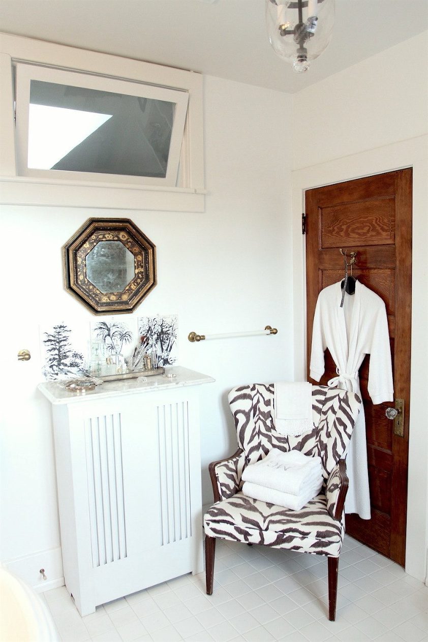 Nancy Keyes - bathroom before - zebra chair - stained wooden door