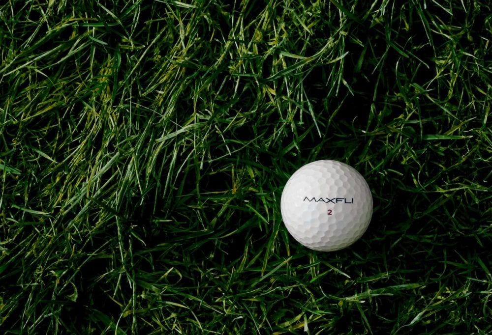 green and white - ben-hershey-golf ball - grass-unsplash