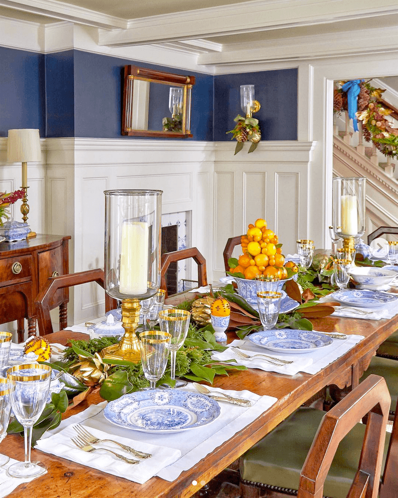 @lisa_hilderbrand on instagram - blue and white tabletop with oranges and greenery - featured in Cottages & Gardens