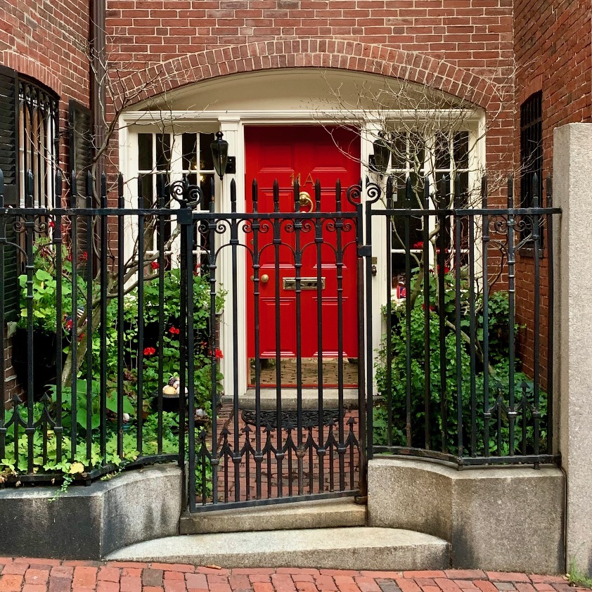 front doors of Beacon Hill - incredible red door - red and green garden - iron fence