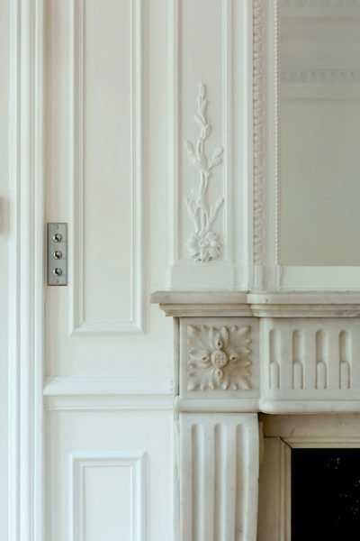 AB Kasha mirror and neoclassical fireplace mantel detail