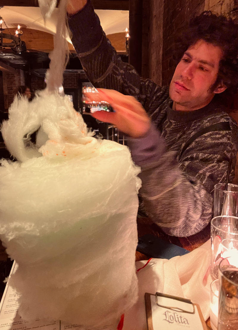 Cale pulling apart cotton candy at Lolita Boston - Thanksgiving 2023