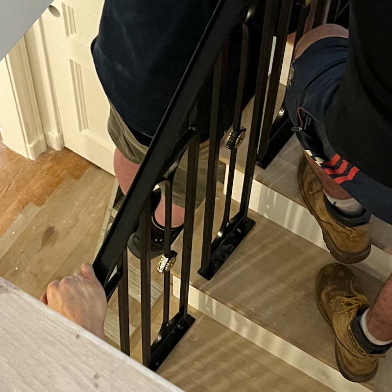 staircase railing installation with ugly plates