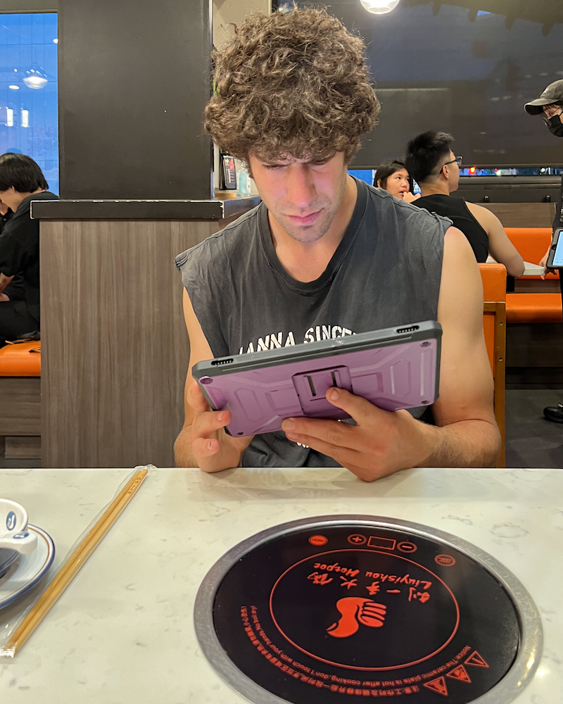 Cale studying a hotpot menu in Boston China town