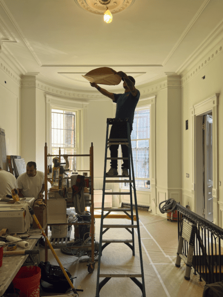 Alex holding up 24 template for alabaster chandelier