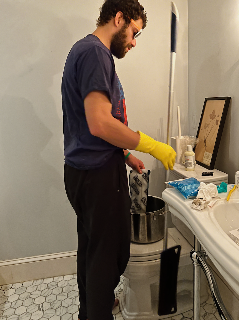 Cale, the oldest child in my family, cleaning bathroom