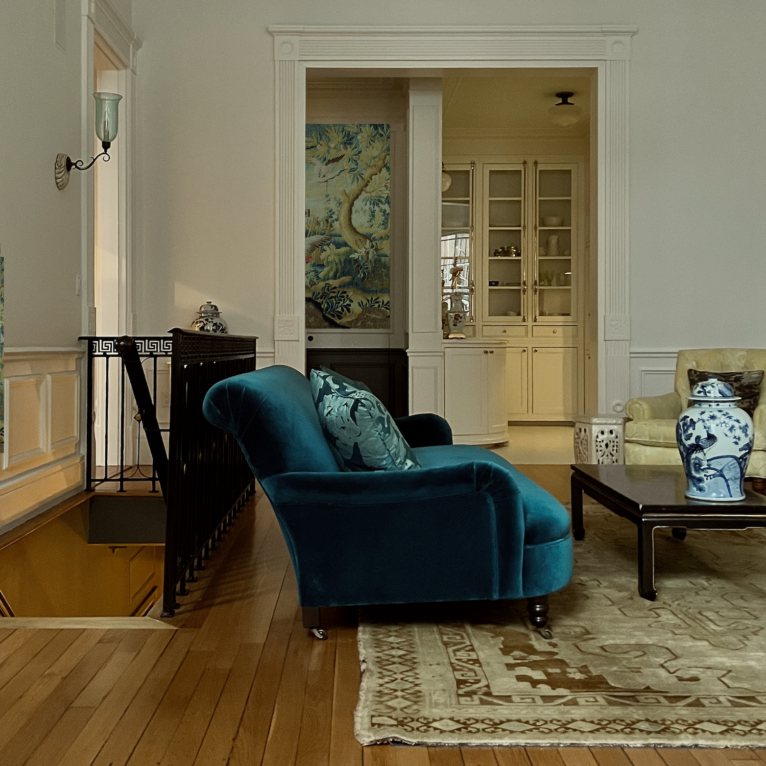 Sofa side view with tapestry wall covering in the entry