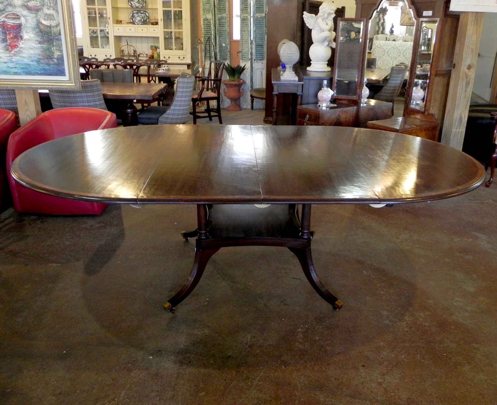 Englishman's mid cherry 60 round birdcage base ext table with leaves. Georgian-Style Dining Table